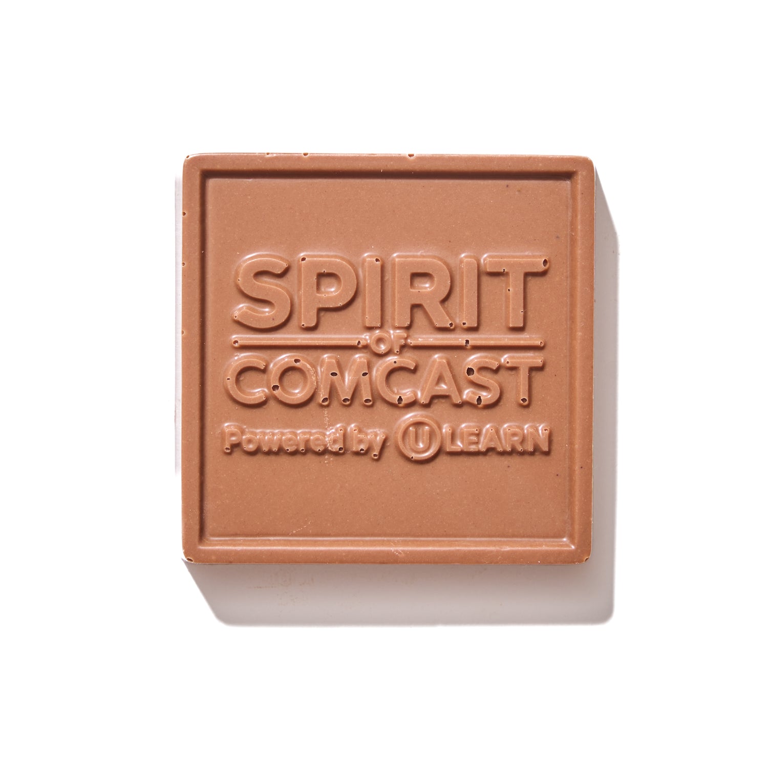 Spirit of Comcast custom milk chocolate square with embossed company logo, handcrafted in Philadelphia.