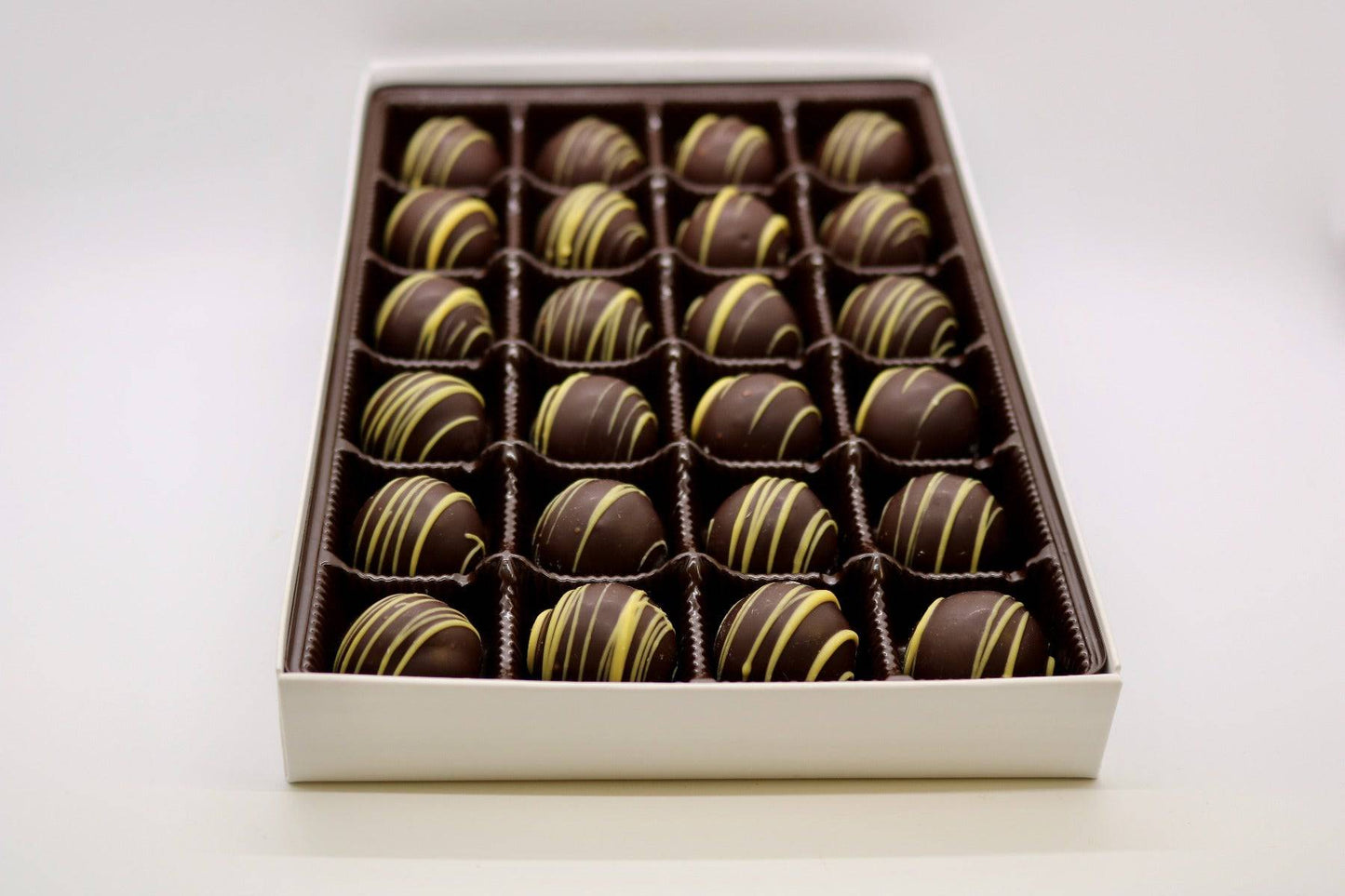 Dark Chocolate Hazelnut Truffles with hazelnut ganache, coated in dark chocolate, in a 24pc gift box.