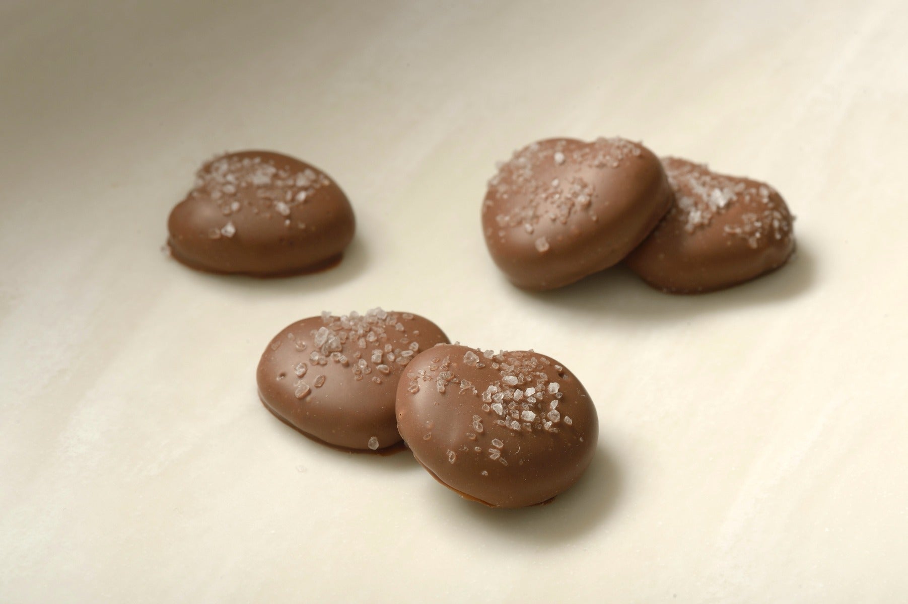 Mini pretzels in caramel and milk chocolate with sea salt topping - a sweet and salty delight from  Mueller Chocolate Co.