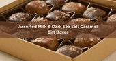 Gift box of assorted milk and dark chocolate sea salt caramels, each piece filled with buttery caramel and topped with a sprinkle of sea salt.