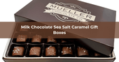 Box of milk chocolate sea salt caramels with golden caramel centers, coated in creamy chocolate and topped with sea salt.