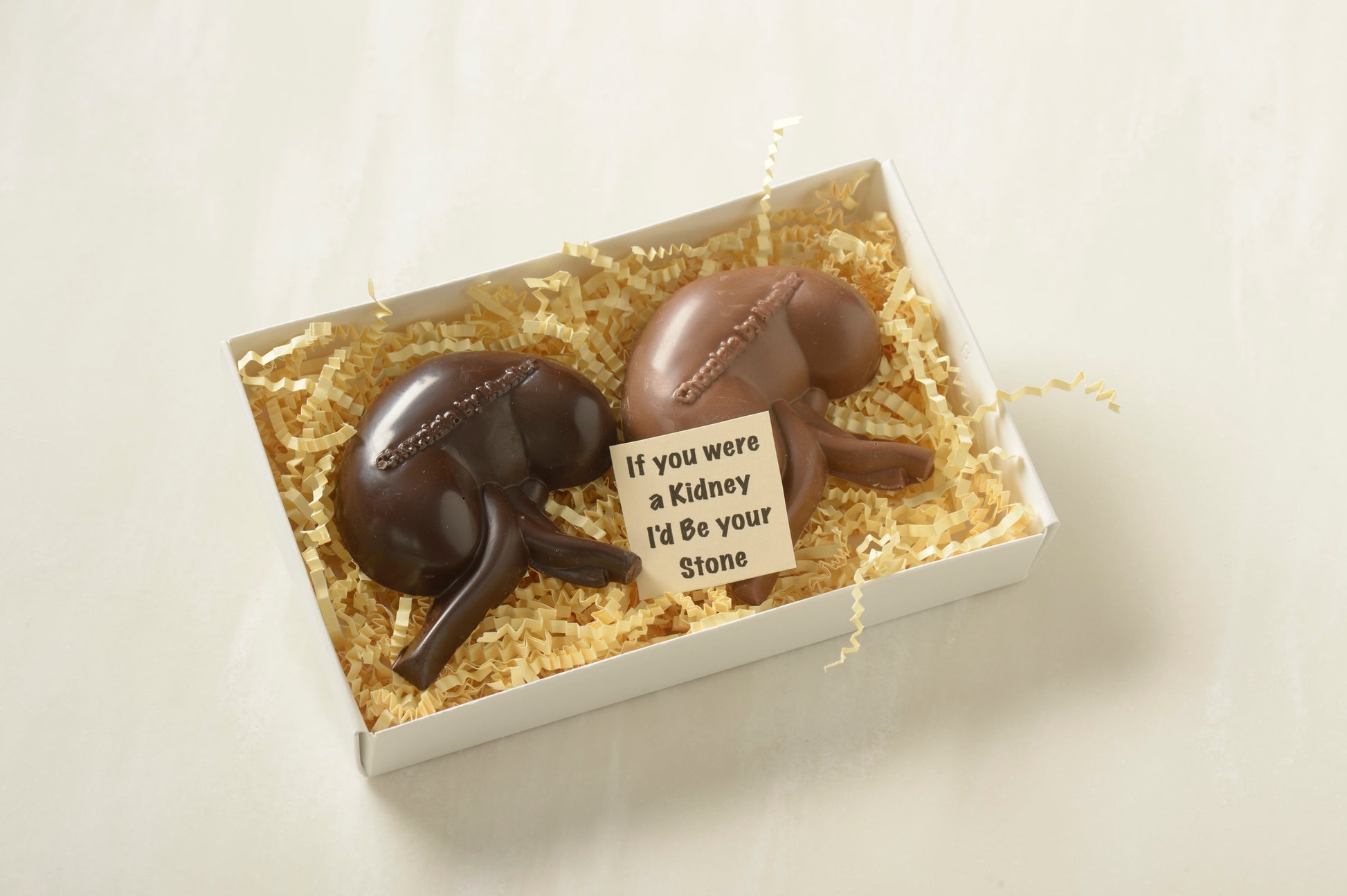 Anatomically correct chocolate kidneys: gourmet milk and dark chocolate molded into kidney shapes, perfect for medical professionals and anatomy enthusiasts.