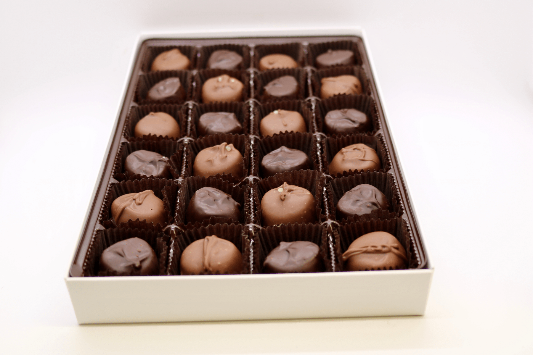 Close-up of assorted vanilla buttercreams in milk and dark chocolate.