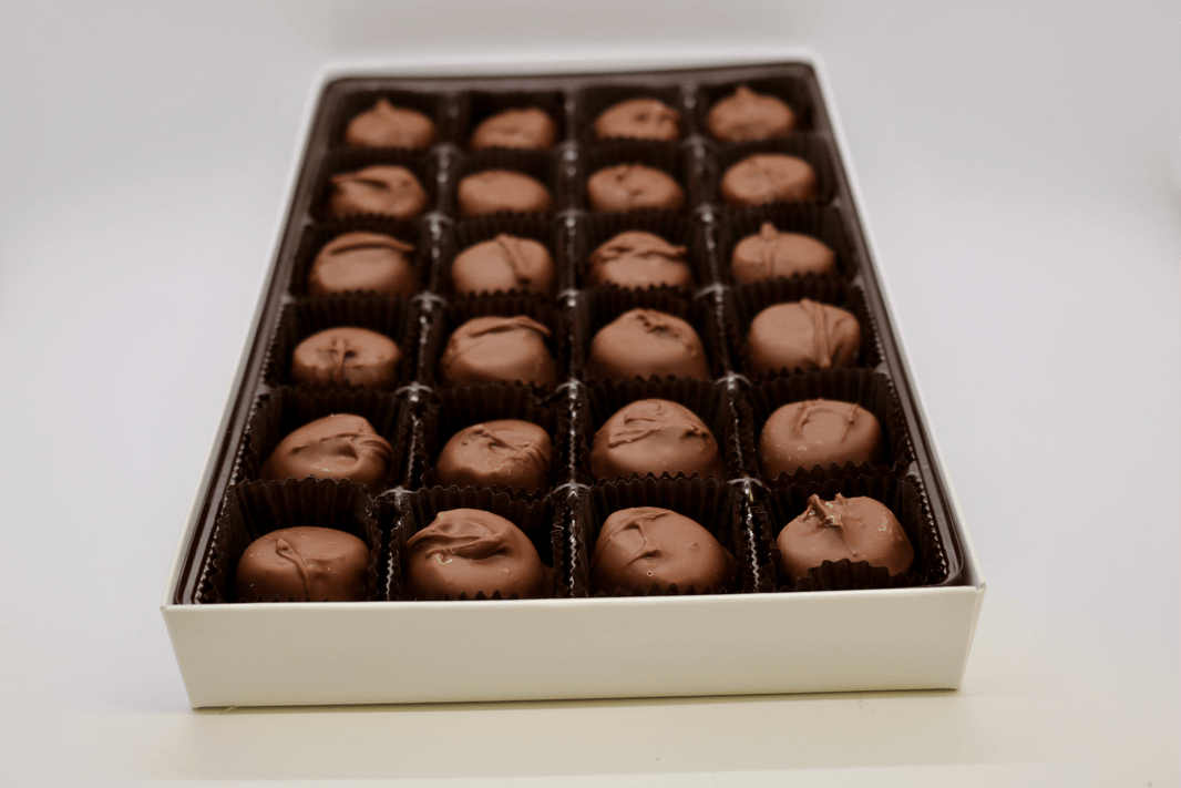 Close-up of handmade milk chocolate vanilla buttercreams with creamy vanilla centers.
